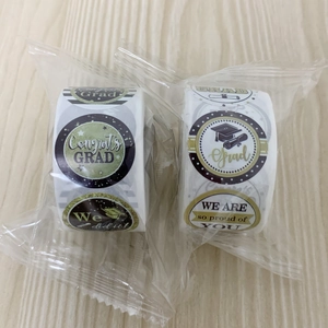 Detail of graduation stickers in black and gold rolls with congrats grad messages