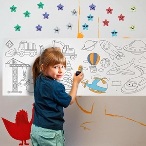 Girl coloring a large self-adhesive wall scroll with vehicles and space themes