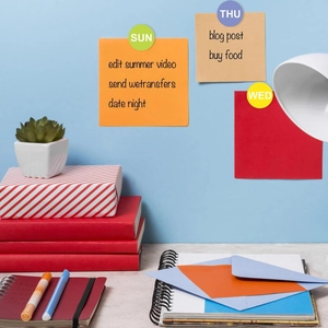 Macro shot of daily planner kit with day-of-week magnetic labels and colorful sticky notes