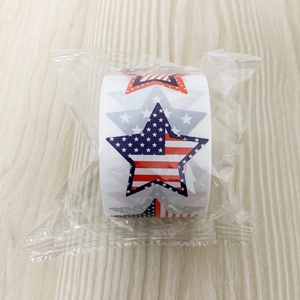 Macro shot of a roll of star stickers with American flag patterns on wood surface