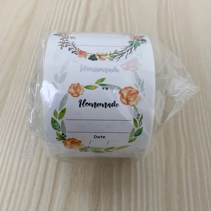 Detail view of floral homemade labels on a roll with date space for food packaging