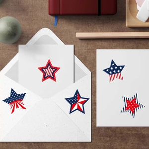 Detail of star-patterned self-adhesive stickers with patriotic themes on a white envelope