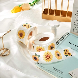 Close-up of sunflower thank you stickers on silk fabric with artistic stationery props