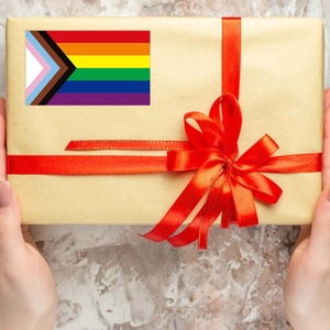 Detail of Progress Pride Flag sticker on a gift box wrapped in brown kraft paper