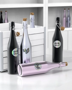Holographic round thermal labels on matte black and silver bottles for vegan cosmetics