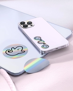 Holographic thermal stickers with ghost and smiley patterns applied on electronic devices