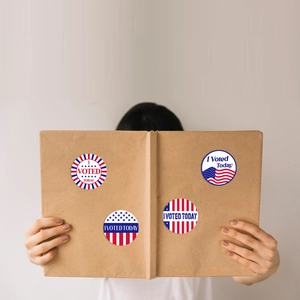 Detailed view of American flag I Voted Today stickers on a kraft paper folder