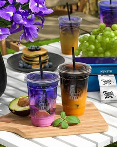 Thermal labels on plastic cups with colorful bubble tea in a summer outdoor setting