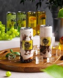 Detail of boba love tea can with chocolate texture on a wooden tray with fresh fruits