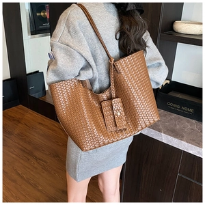 Detail shot of vintage brown woven leather tote bag with matching card holder pouch