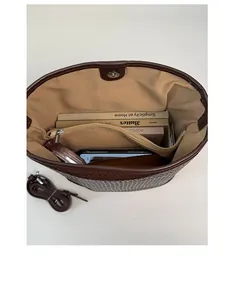 Spacious interior of brown woven bucket bag showing large capacity and zipper pocket