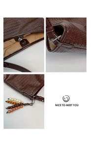 Detail of dark brown woven leather bucket bag featuring magnetic clasp and wooden bead charm