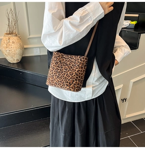 Détail du sac seau à imprimé léopard avec texture douce et fine bandoulière en cuir