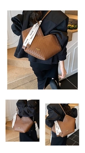 Detail of a brown woven leather tote bag with V-cut opening and decorative ribbon handle