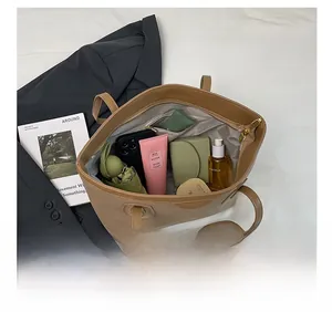 Macro view of khaki tote bag interior showing spacious capacity for daily essentials