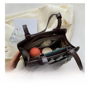 Interior view showing the spacious compartments and zipper pockets of this retro handbag