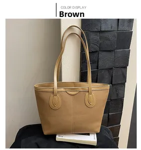 Detail view of brown matte vintage tote bag with dual straps and vertical stitching detail