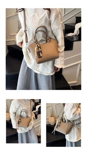 Detail of khaki bucket bag featuring a chocolate charm and knotted chain handle