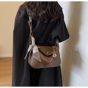 Brown lychee leather Lindy style bag with a geometric silk scarf detail on the handle