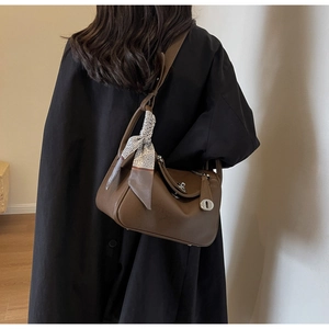 Rear view of brown lindy bag with litchi grain leather and decorative silk scarf