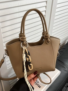 Litchi pattern leather bucket bag in khaki brown with unique knot handles and rope detail