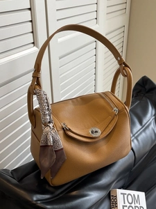 Brown litchi leather handbag with unique U-zip closure and decorative silk scarf detail