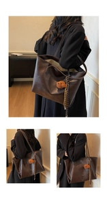 Detail of dark brown tote bag with vintage texture, plush bear and striped woven strap