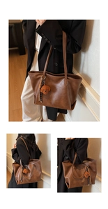 Detail view of large brown tote bag with leather texture and cute plush bear charm