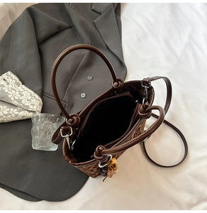 Detailed top view of leopard print bucket bag interior with black lining and zip pocket