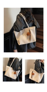 Close-up of white tote bag with faux leather texture and a cute brown bear charm