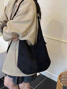 Minimalist black faux suede large tote bag for women shown in a casual lifestyle setting