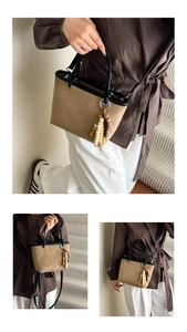 Detail of khaki frosted suede tote bag with black leather trim and bead tassel