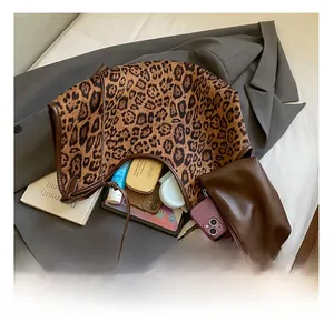 Detail view of large leopard print tote bag interior showing spacious capacity for daily items