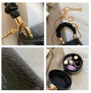 Dettagli borsa a cilindro nera texture coccodrillo con manico a nuvola e catena oro