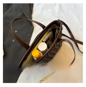 Internal view of dark brown checkered woven tote bag showing spacious storage for essentials