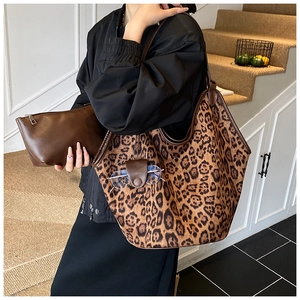 Large leopard print tote bag and dark brown clutch bag set shown in a lifestyle setting