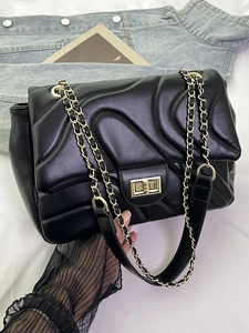 Chic black quilted wave pattern underarm bag with gold chain and metal twist lock