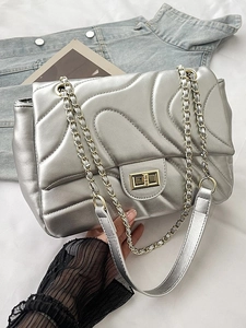 Silver quilted underarm bag with gold chain strap and wave pattern metallic finish