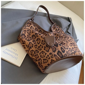 Close-up of leopard print texture and brown leather trim on a large tote bag