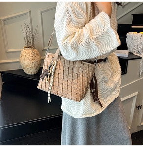 Close-up of woven handbag texture featuring chocolate charm and stylish braided strap