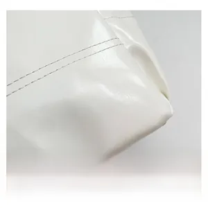 Detailed close-up of white glossy faux leather tote bag with precise double stitching
