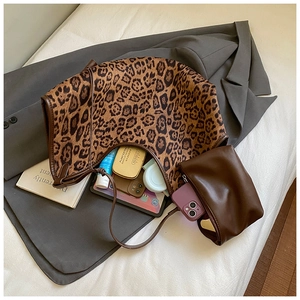 Detail of leopard print tote bag interior capacity with matching pouch and accessories