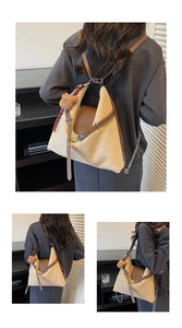 Detail of beige canvas tote with brown leather trim and cute plush bear charm