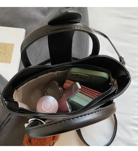 Top view of black pebbled leather bucket bag showing spacious interior and zip pocket