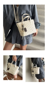 Detail of cream woven leather handbag with chocolate charm and detachable strap