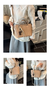 Detail view of woven khaki tote bag showing handheld and crossbody styling options