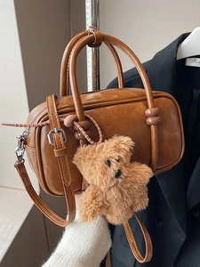 Brown vintage faux leather bowling bag with cute plush bear charm and crossbody strap