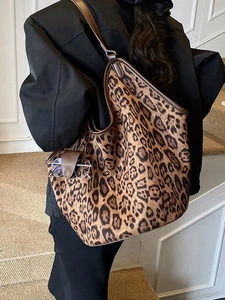 Large leopard print tote bag with brown leather trim and shoulder strap for women