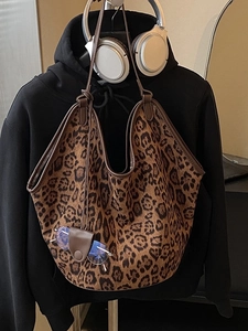 Leopard print tote bag with large capacity and leather trim on a casual outfit