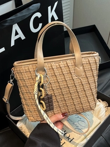 Retro woven light brown tote bag with chocolate charm and crossbody strap details